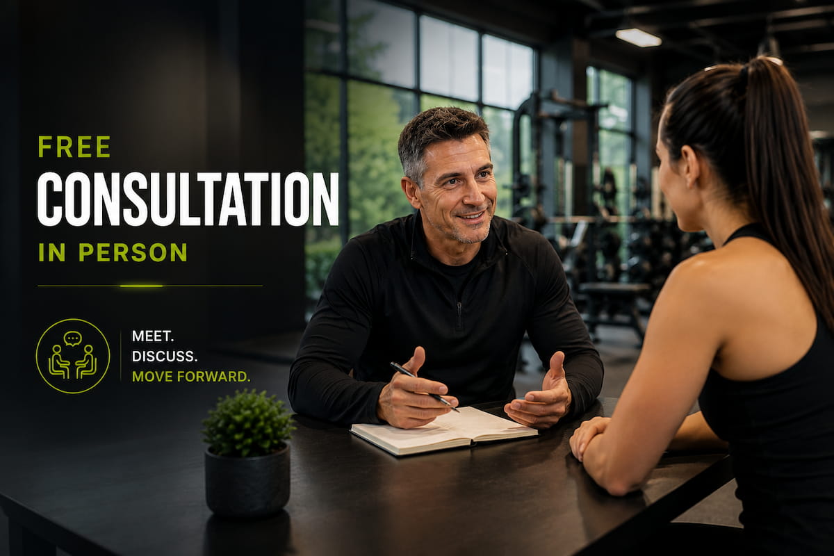 Personal trainer speaking with a client during an in-person consultation at the gym.